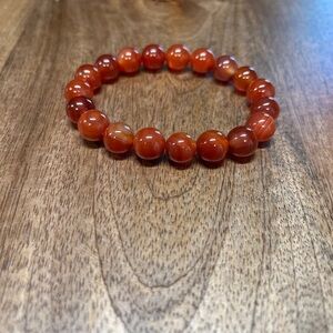 New without tags stretchy burnt red orange tone stone bracelet stretchy